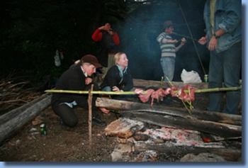 group around a BBQ and campfire on a trailriding for beginners program.